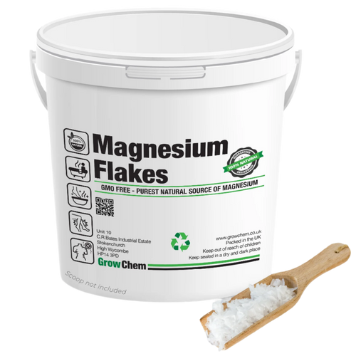 Tub of magnesium flakes from GrowChem with visible branding and a wooden scoop showing the white mineral flakes.